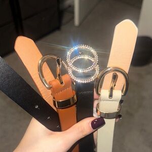 Elegant Black, Tan, and Cream Belt Set with Gold Buckles